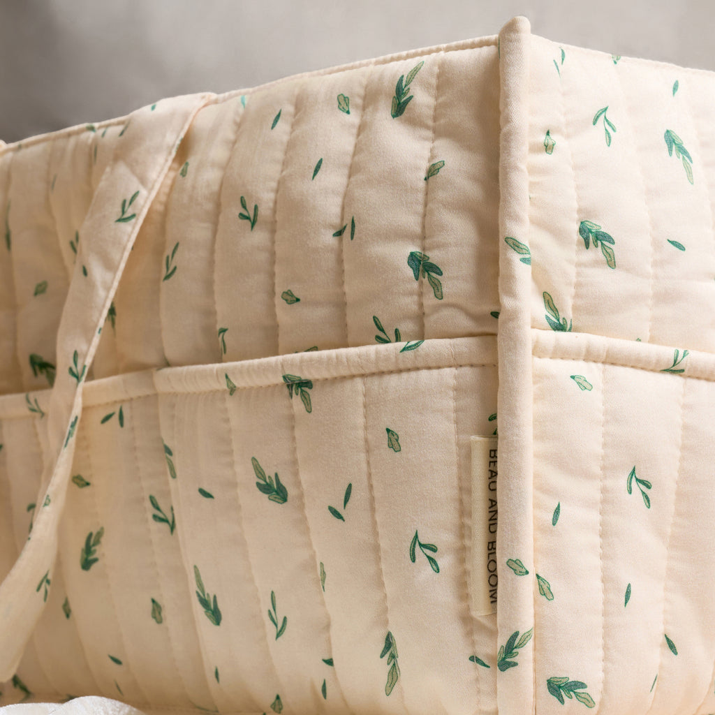 Quilted organic cotton nappy caddy with compartments for baby essentials