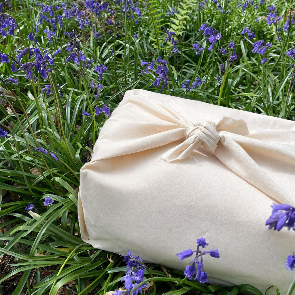 Baby gift hamper wrapped in reusable calico fabric furoshiki style