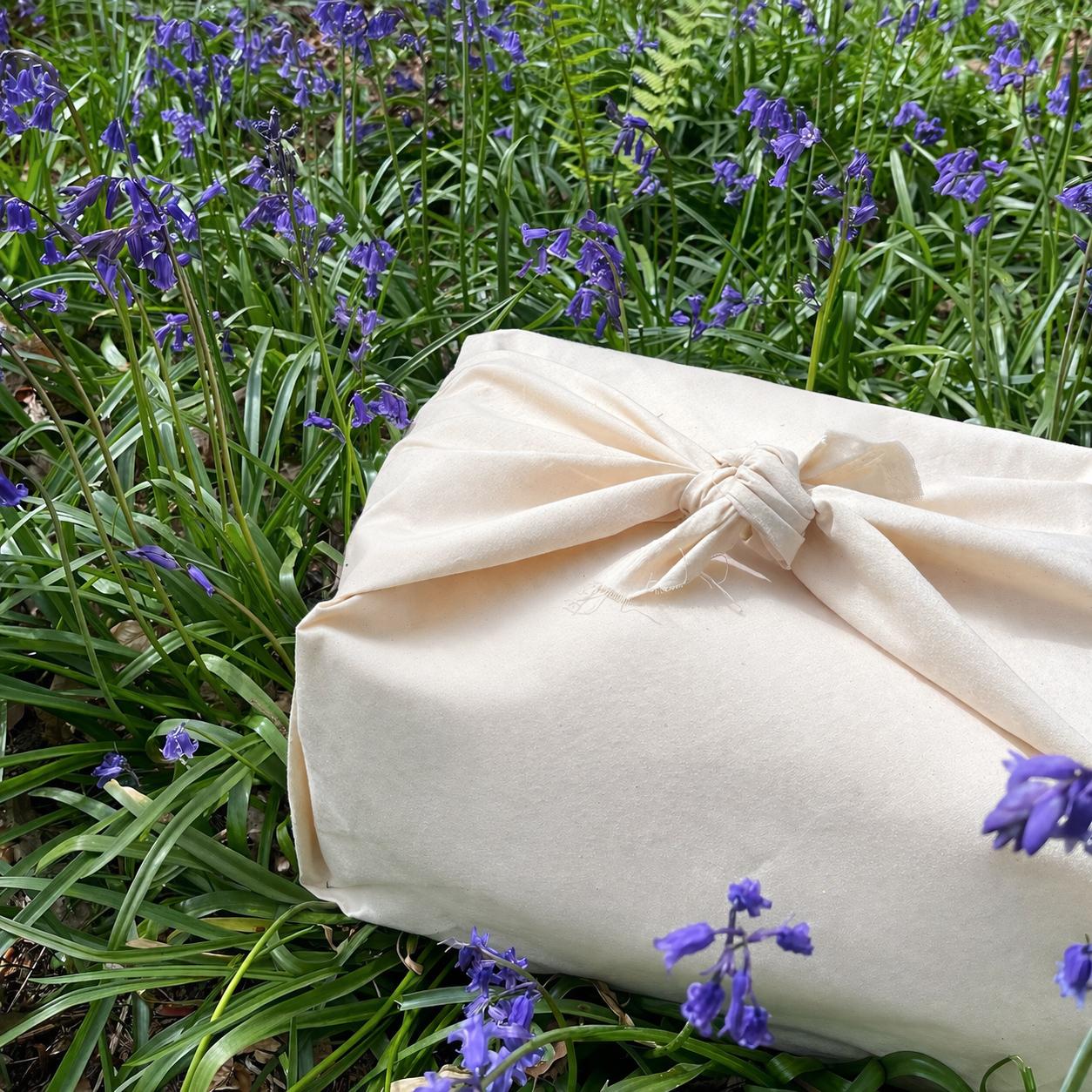 Baby gift hamper wrapped in reusable calico fabric furoshiki style