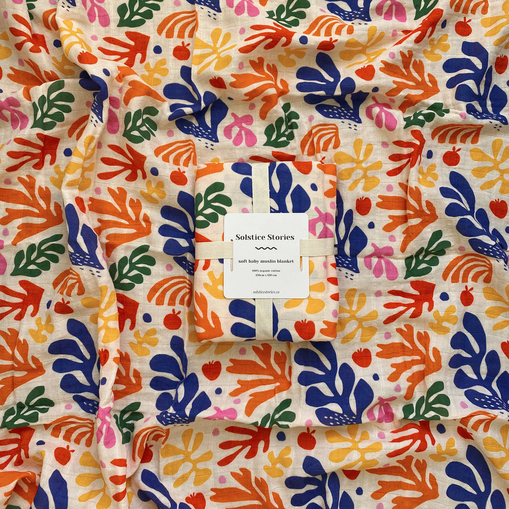 Organic cotton muslin swaddle with colourful floral pattern